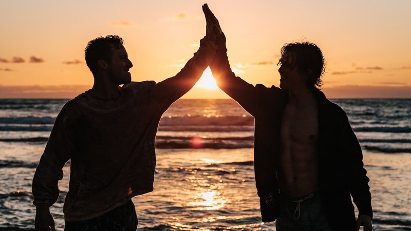 Two men at sunrise high-fiving ED Facts