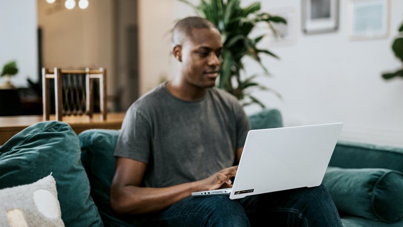 Man sitting on coach with laptop - low blood flood cause