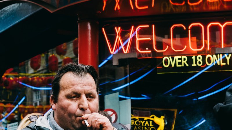 man smoking outside bar - low blood flow